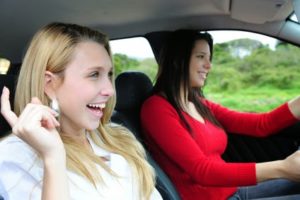 two happy women in a car